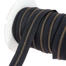 Fermeture éclair au mètre largeur 6 mm finition laiton vieilli ruban noir