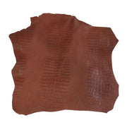 Peau de cuir de basane imitation crocodile marron brique, finition aniline, vue détaillée de la texture et la couleur.